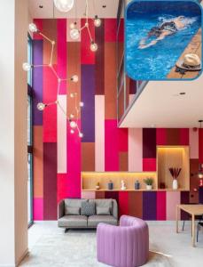 a living room with a colorful striped wall at ARCELON HOTEL - 10 min walking to Sagrada Familia in Barcelona