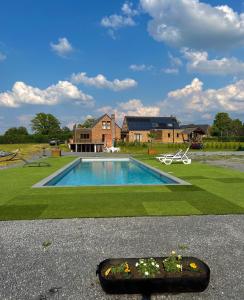 a backyard with a swimming pool and a house at Les gîtes du Valjoly 1 in Touvent