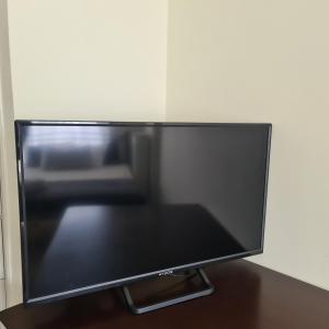 En TV eller et underholdningssystem på Christina´s Beachside Apartment