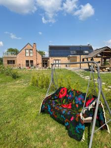 a blanket laying on a swing in a field at Les gîtes du Valjoly 1 in Touvent +22 photos