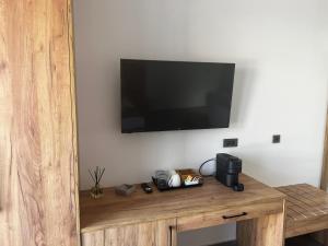 a flat screen tv hanging on a wall at Sydney Hotel in Kefalos