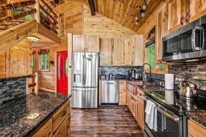 a kitchen with wooden cabinets and a stainless steel refrigerator at Sunrise View Chalet in Gatlinburg