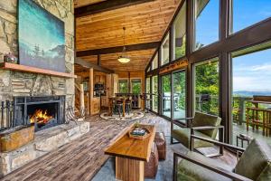 an open living room with a fireplace in a house at Sunrise View Chalet in Gatlinburg