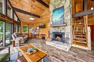 a living room with a fireplace in a log cabin at Sunrise View Chalet in Gatlinburg