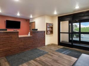 a living room with a flat screen tv on a wall at My Place Hotel Rapid City in Rapid City