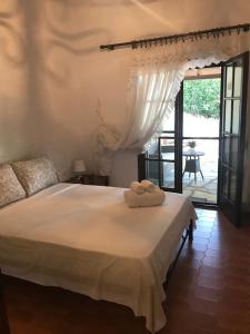 a bedroom with a bed with two towels on it at Sani Garden House in Sani Beach