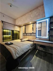 a bedroom with a large bed and a window at Nawasena Studio at Solo Paragon Apartment in Solo +16 photos