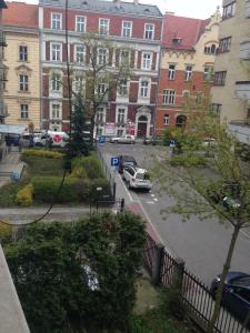 a city street with cars parked in front of buildings at Cybulskiego Guest Rooms in Krakow