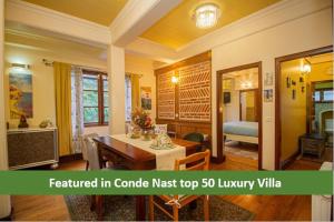 a living room with a table and a dining room at Amritara Luxury Villa Tosca, Gangtok in Gangtok