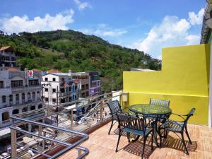 a balcony with a table and chairs on a building at Sukcheewa Residence Phuket in Patong Beach