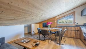 a small kitchen and dining room with a table and chairs at Résidence W 2050 - BELLE PLAGNE in Belle Plagne