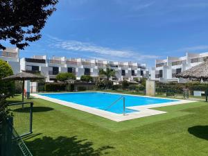 a large swimming pool in front of a building at Fontanilla 58 Casa Lucia with pool and garage at Playa Conil in Conil de la Frontera