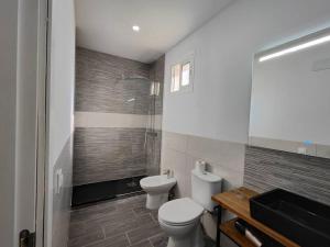 a bathroom with a toilet and a shower at Fabulous Penthouse in La Línea de la Concepción