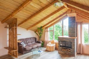 a living room with a couch and a fireplace at Irina in Soko Banja