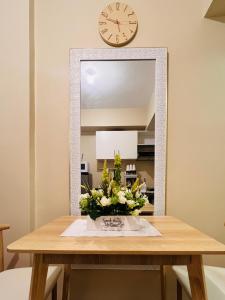 a dining room table with a mirror and a clock at * * * J Travellers' Choice 2023 in Iloilo City