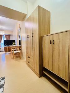 a room with wooden cabinets and a dining room at * * * J Travellers' Choice 2023 in Iloilo City