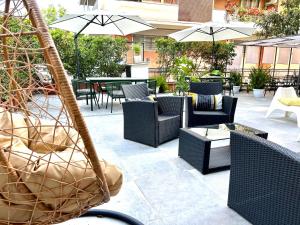 a patio with chairs and tables and umbrellas at Hotel Franchi in Florence