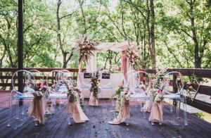 an outdoor wedding ceremony with white chairs and a canopy at Euro Hotel Gradche in Kočani
