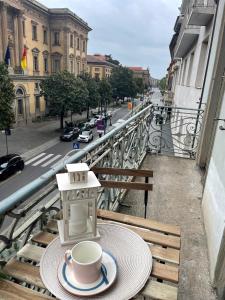 a cup of coffee on a table on a balcony at Relais Dei Mandorli suite centro in Bergamo