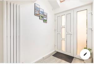 a hallway with white walls and a door at En-suite room in central Milton Keynes in Milton Keynes