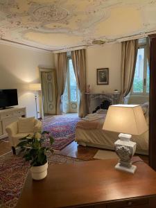 a bedroom with a bed and a table with a lamp at Relais Dei Mandorli suite centro in Bergamo