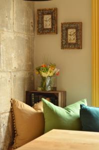 a living room with a couch and a vase of flowers at The Griffin Inn Bath in Bath
