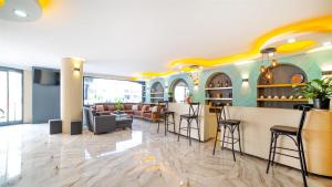 a lobby with a bar with stools and chairs at Blue Marina Hotel & Spa in Antalya
