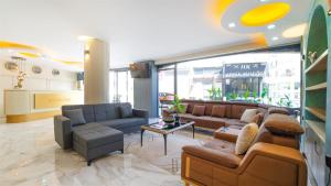 a living room with couches and chairs in a store at Blue Marina Hotel & Spa in Antalya