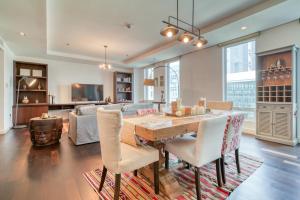 a kitchen and living room with a wooden table and chairs at Limestone House, Dubai International Financial Centre - Mint Stay in Dubai