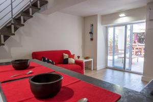 a living room with a red couch and a red rug at Teatro Apartments Mondello in Palermo