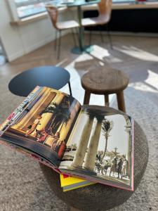 uma pilha de livros em cima de uma mesa em Home away from home em Oostende