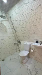 a white bathroom with a toilet and a sink at Magical space Tsikhisdziri in Tsikhisdziri
