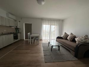 a living room with a couch and a table at Dacia Apartments in Sebeş