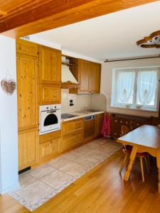 a kitchen with wooden cabinets and a white oven at Haus Jomeity in Sillian