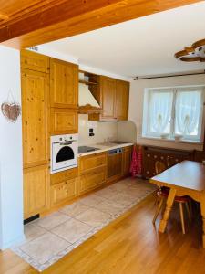 a kitchen with wooden cabinets and a white oven at Haus Jomeity in Sillian +9 photos