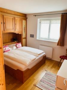 a bedroom with a large bed and a window at Haus Jomeity in Sillian