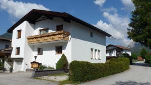 een wit gebouw met een houten balkon bij Haus Ferdinand in Leutasch