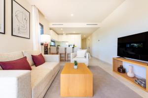 a living room with a couch and a tv at Jardiana Lotus - Walking distance to La Cala De Mijas in La Cala de Mijas