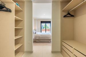 a bedroom with a bed and a walk in closet at Jardiana Lotus - Walking distance to La Cala De Mijas in La Cala de Mijas +21 photos