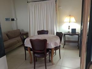 a living room with a table and chairs and a couch at La rue de Rox ,apart in Corrientes