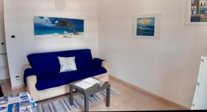 un soggiorno con divano blu e tavolo di Appartamento 5terre Portovenere a Portovenere