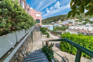 a stairway leading up to a building with a city at Albergo Le Querce in Ponza