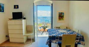 a bedroom with a bed and a view of a balcony at Appartamento 5terre Portovenere in Portovenere