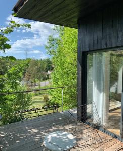 a screened in porch with a basket on the deck at La Cabane in Bouliac