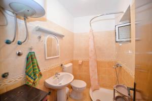 a bathroom with a sink and a toilet and a shower at Apartments Goran in Kotor +27 photos