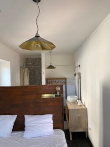 的住宿－Breakfast Under A Tree Apartamento，一间卧室配有一张带木制床头板和水槽的床。