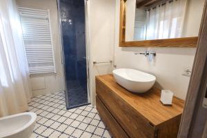 a bathroom with a sink and a shower at Casa Margot in Sutri +6 photos