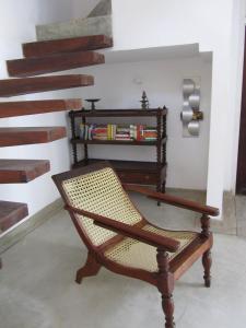 a chair sitting in a room with a staircase at Isana Beach House in Tangalle