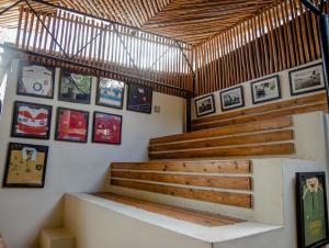 a staircase in a room with pictures on the wall at The Slow Leopard in Dar es Salaam