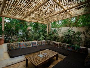 a living room with a couch and a table at The Slow Leopard in Dar es Salaam